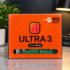 Orange retail box for a 7-in-1 watch strap, labeled ULTRA 3 and BIG 2.01", shown on a tabletop with a plant and lamp in the background.
