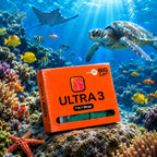 An orange box of Ultra 3 7-in-1 stretch straps is placed on a coral reef in an underwater ocean scene with a sea turtle, stingrays, and colorful fish swimming around it.