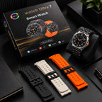 A smart watch displayed with its retail box, three interchangeable silicone straps in black, white, and orange, and a black watch stand on a dark tabletop.